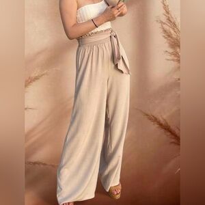 Beige wide leg pants with elastic ruffle waistband and tie belt